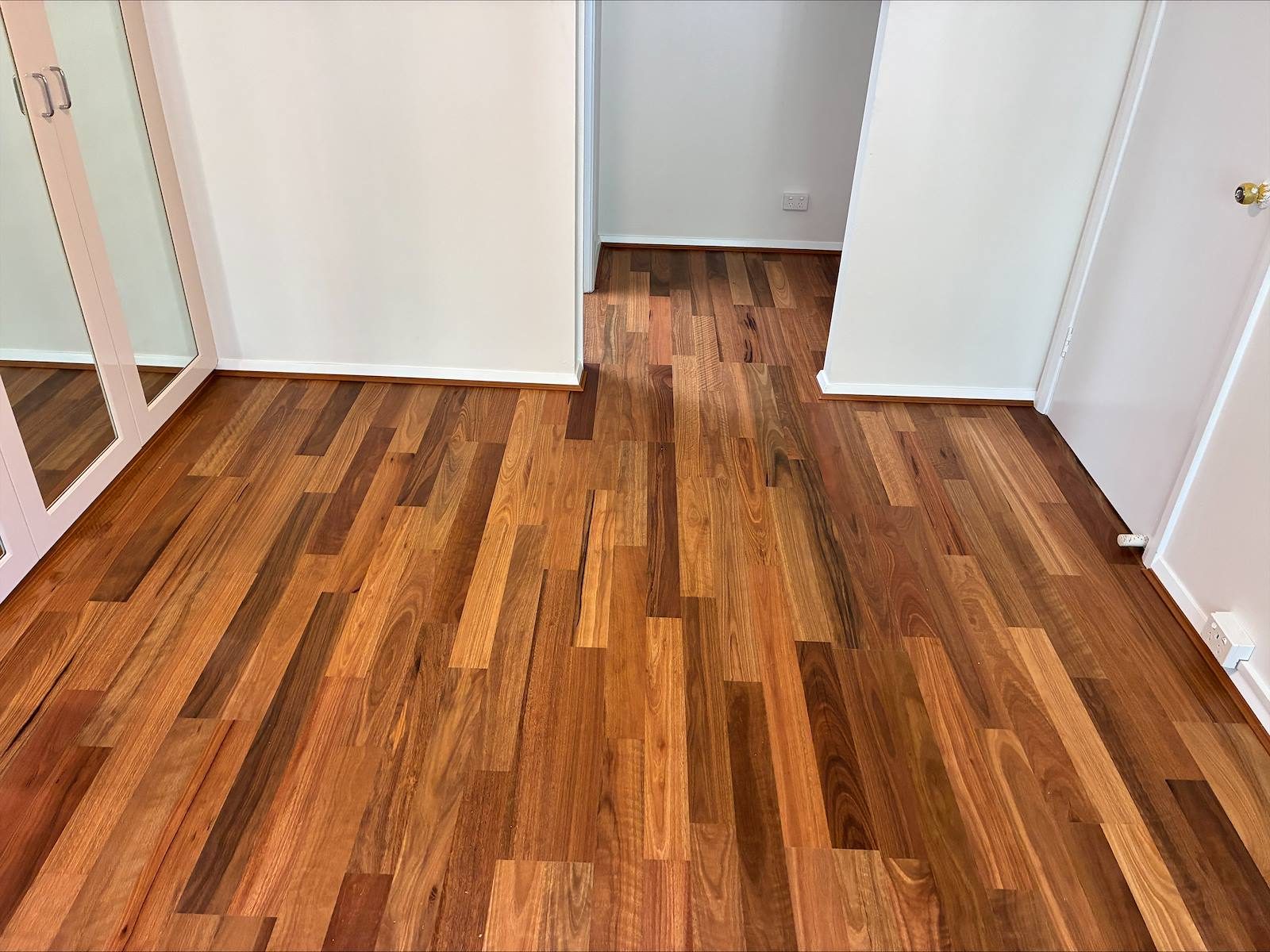 Spotted gum flooring running the length of a hallway