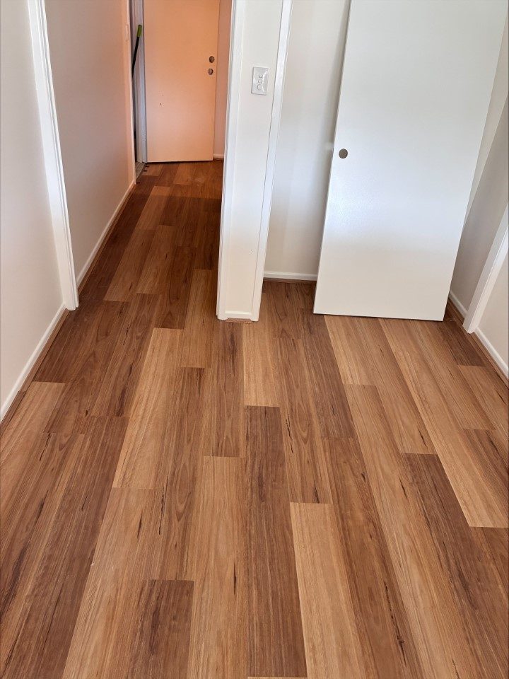 Timber plank flooring running down a hallway