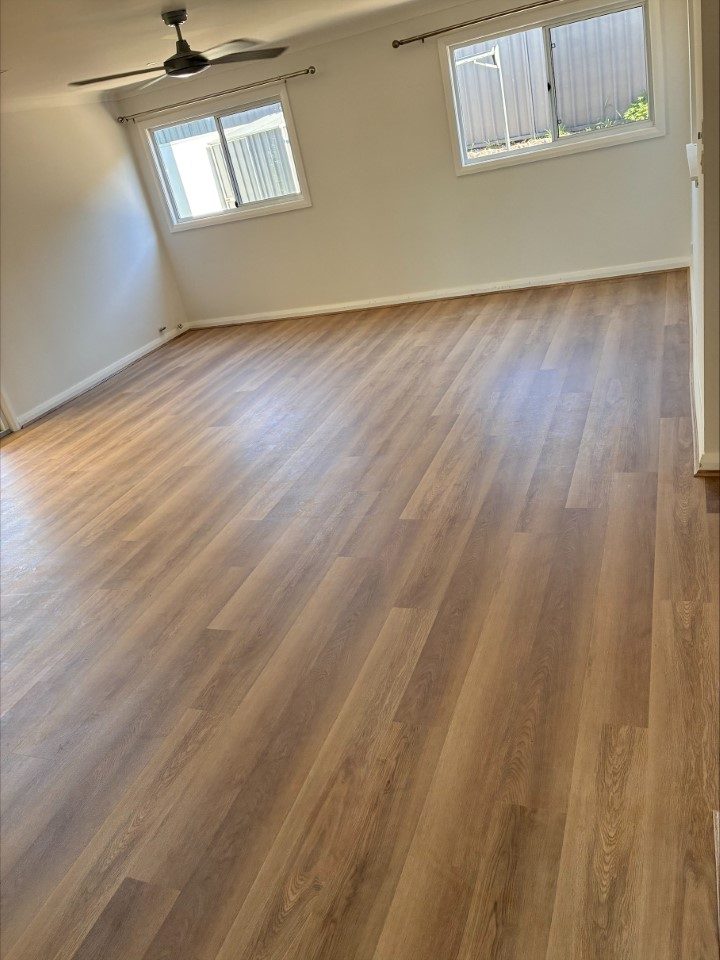 Wide-plank timber flooring in a bright, sunlit living room